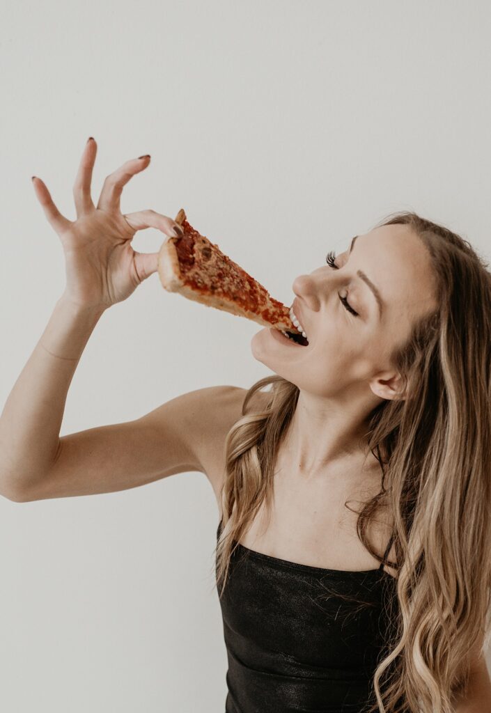 Female eating a Chicago deep dish pizza.