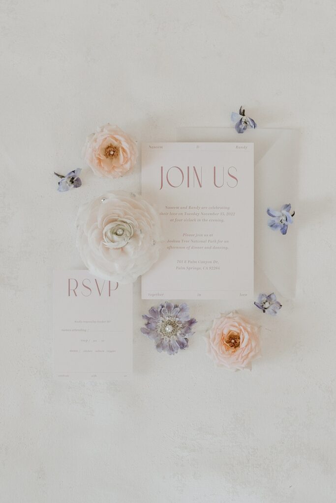 Flat lay with wedding invitation and florals