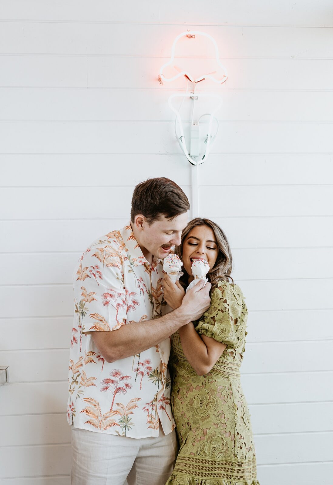 Close up of couple eating off of one another's ice cream cone