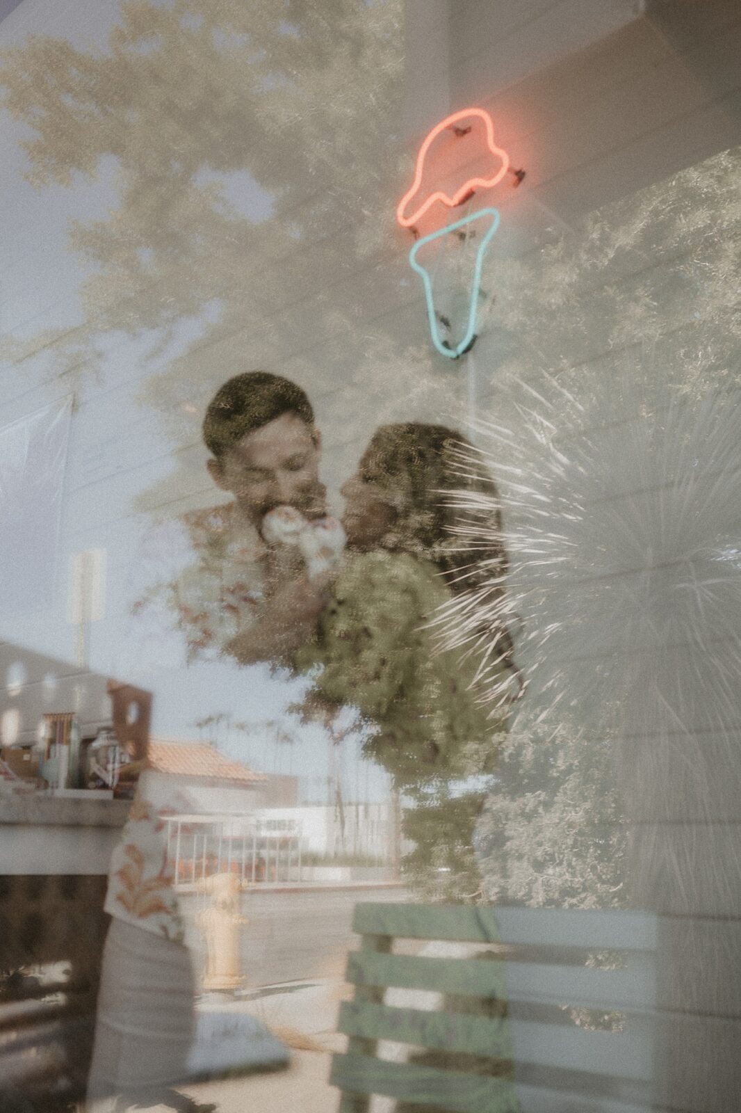 Couple inside of ice cream shop in downtown Palm Springs, image captured from outside window