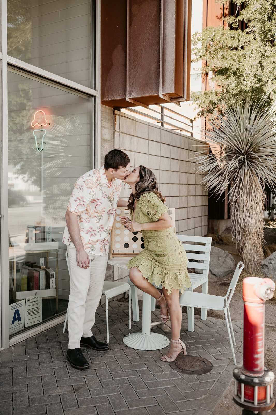 Couple kissing after playing a game of lawn size connect four