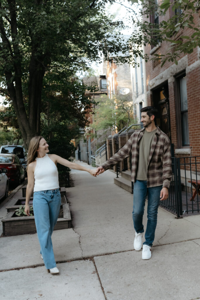 Casual documentary-style engagement photos on a city sidewalk