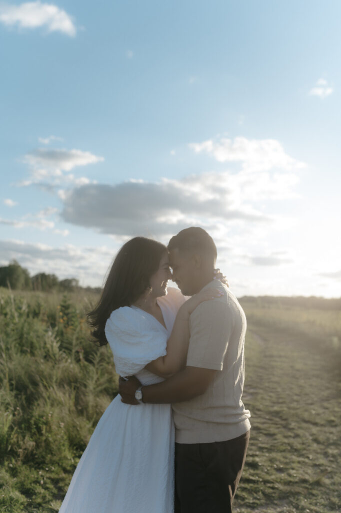 A couple embracing during an authentic engagement session to show the beauty of natural directing over stiff posing.