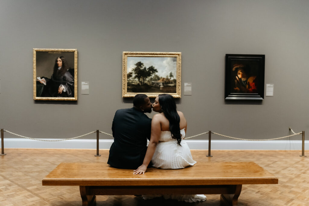 Bride and groom kissing and staying present at the Art Institute of Chicago.