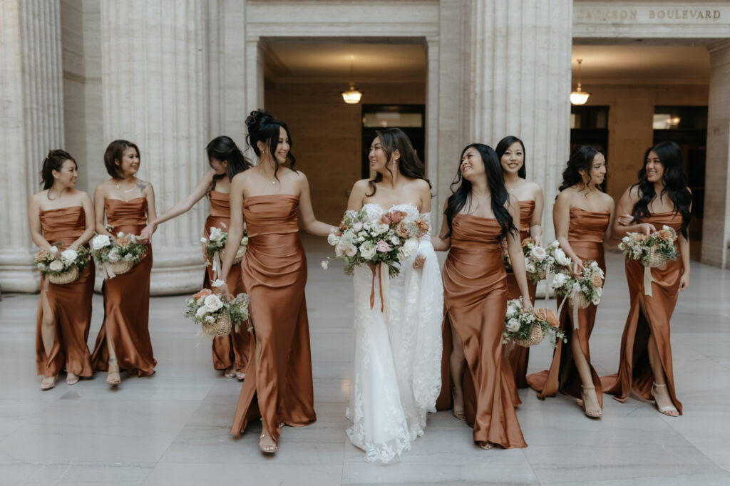 Bridesmaids walking and laughing with the bride as a great wedding day hype crew.