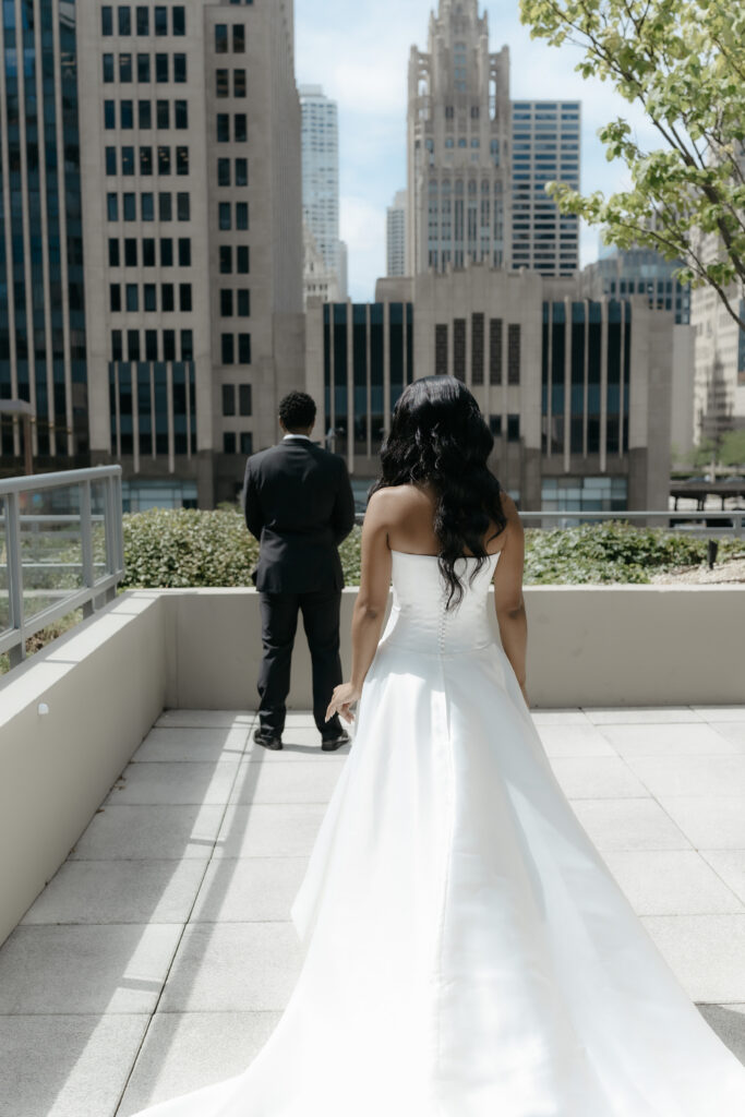 A bride and groom sharing a quiet moment during a luxury rooftop first look portrait session downtown.