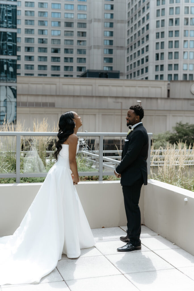 An emotional groom reaction on a secluded terrace.